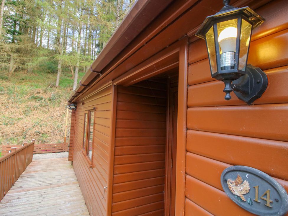 A wooden exterior with a lamp and house number at No.14 Astbury Falls Luxury Retreat in Bridgnorth