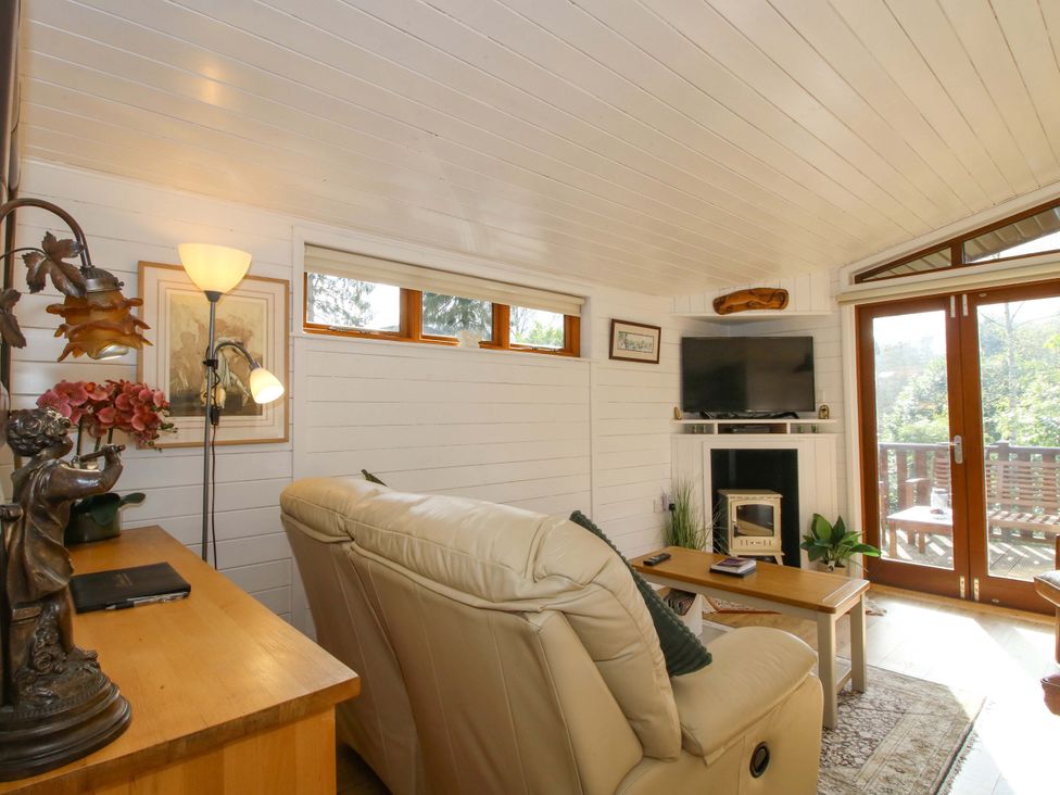 A living room with a sofa and television at No.14 Astbury Falls Luxury Retreat in Bridgnorth