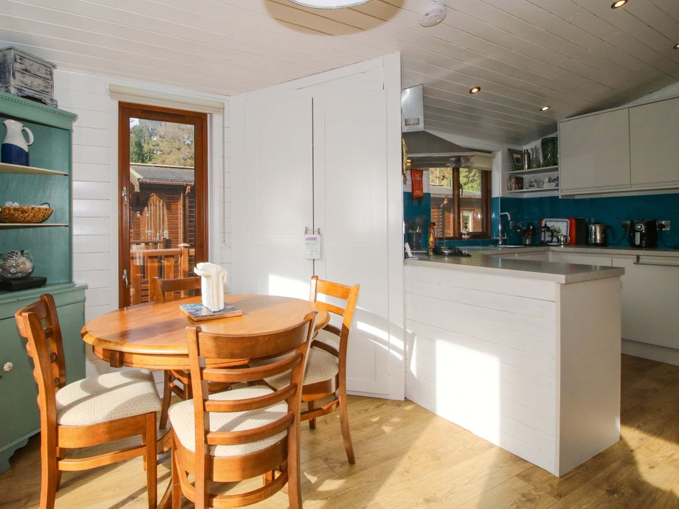 A kitchen with a round table and chairs at No.14 Astbury Falls Luxury Retreat in Bridgnorth