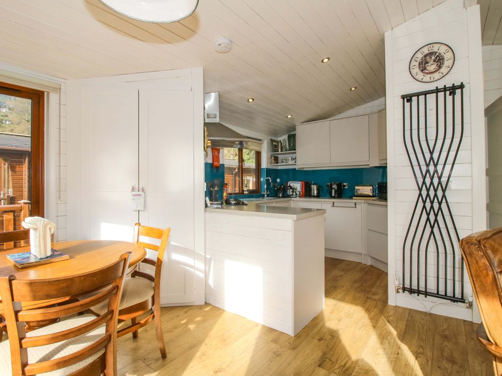 A kitchen with a dining table and chairs at No.14 Astbury Falls Luxury Retreat in Bridgnorth