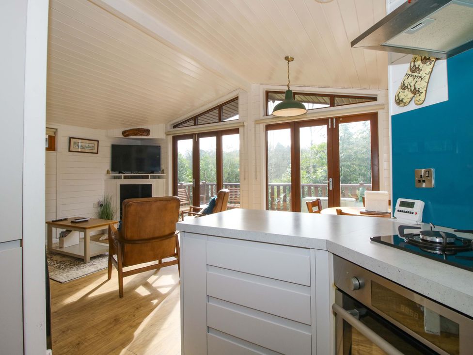 A living room with a television and a sofa at No.14 Astbury Falls Luxury Retreat in Bridgnorth