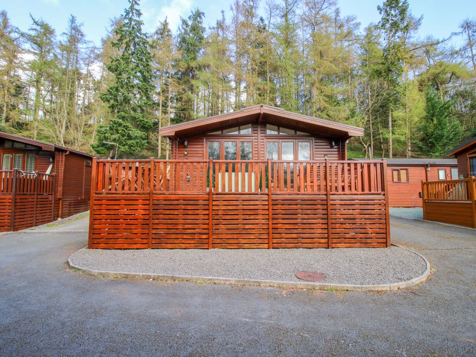 A log cabin with a wooden fence and paved driveway at No.14 Astbury Falls Luxury Retreat in Bridgnorth