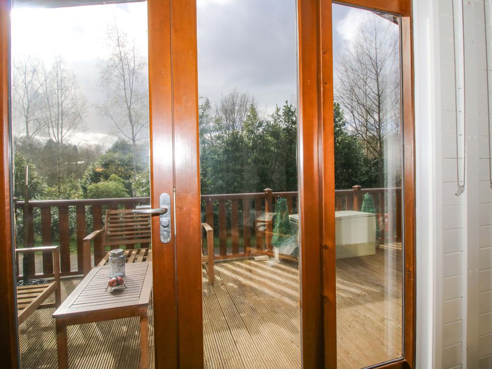 A patio area with a table and chairs at No.14 Astbury Falls Luxury Retreat in Bridgnorth