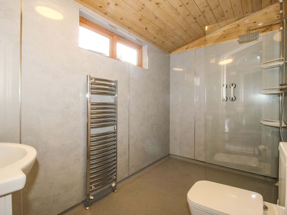 A bathroom with a shower and wash basin at No.14 Astbury Falls Luxury Retreat, Bridgnorth