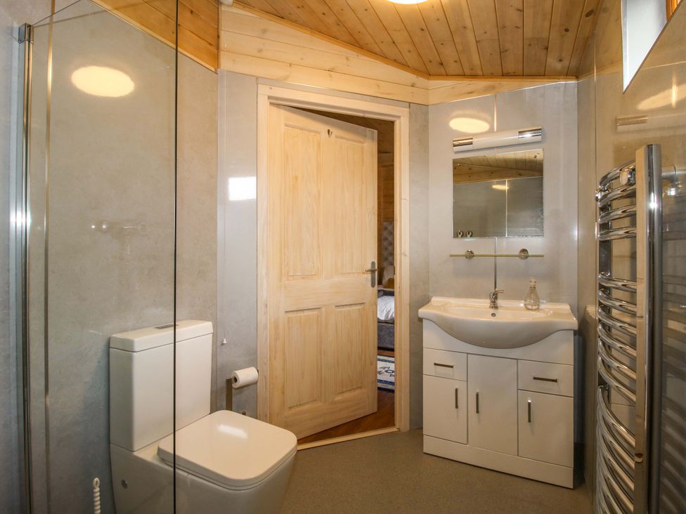 A bathroom with a toilet and sink at No.14 Astbury Falls Luxury Retreat in Bridgnorth