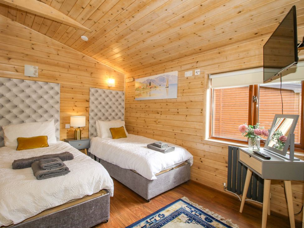 A bedroom with two beds and a television at No.14 Astbury Falls Luxury Retreat, Bridgnorth