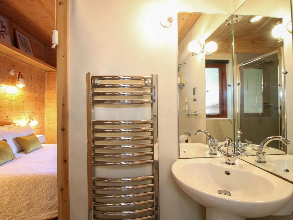 A bathroom with a sink and towel radiator at No.14 Astbury Falls Luxury Retreat, Bridgnorth