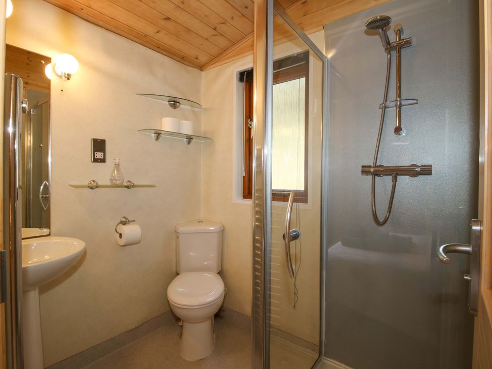 A bathroom with a shower, sink, and toilet at No.14 Astbury Falls Luxury Retreat in Bridgnorth