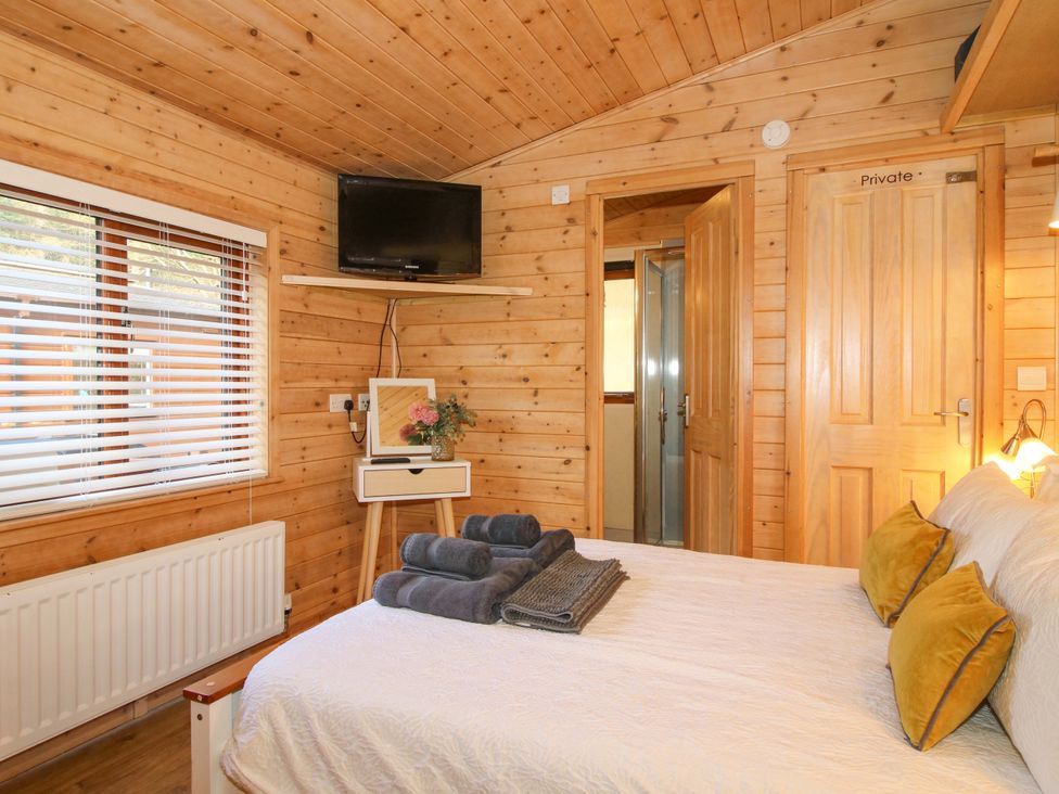 A bedroom with a bed and television at No.14 Astbury Falls Luxury Retreat, Bridgnorth