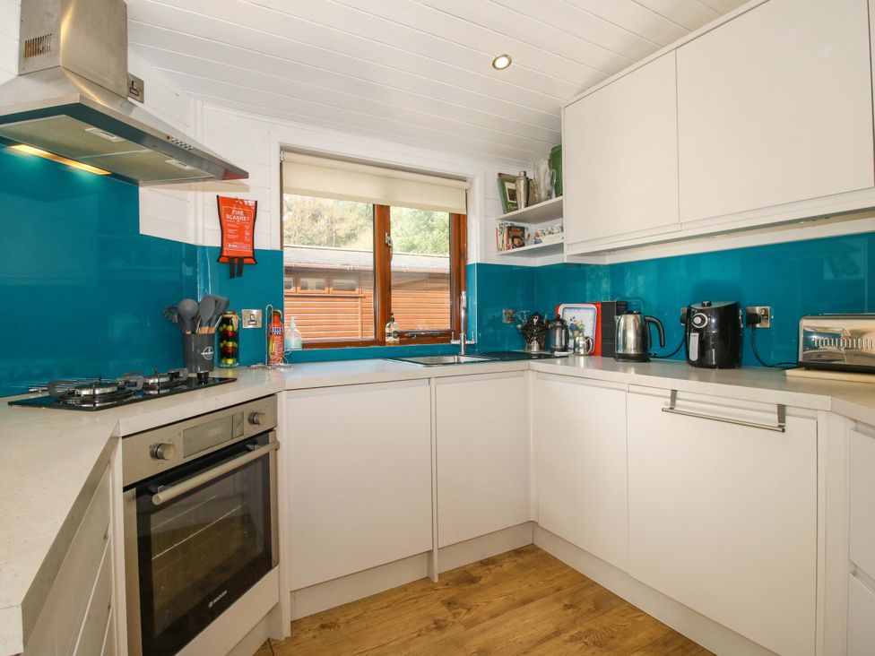 A kitchen with appliances and window at No.14 Astbury Falls Luxury Retreat in Bridgnorth