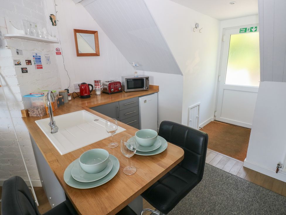 A kitchen with sink and appliances at Seaside Steps in Goodwick