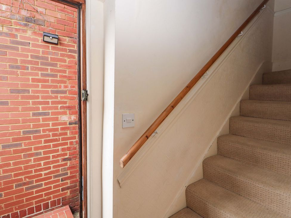 A staircase leading to upper levels at Daisy Cottage 22 Chalkpit Terrace, Dorking