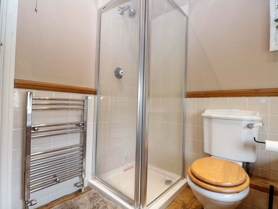 A bathroom with a shower and a toilet at Daisy Cottage 22 Chalkpit Terrace Dorking