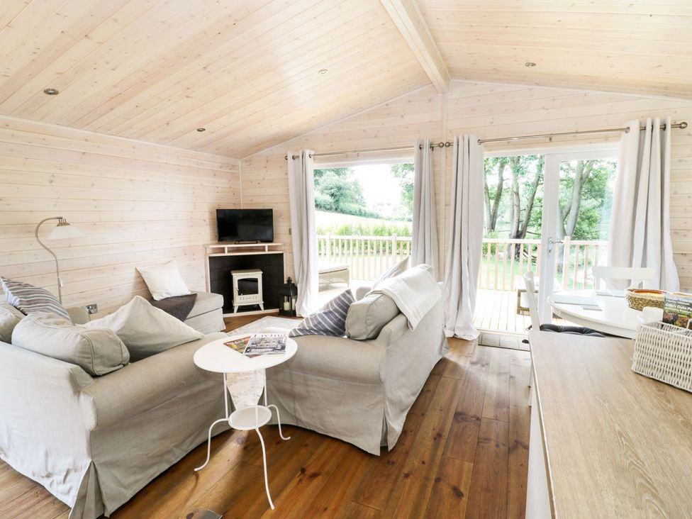 A living room with seating and a television at Skylark in Ross-on-Wye