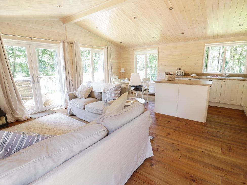 A living room with a sofa and dining area at Skylark in Ross-on-Wye