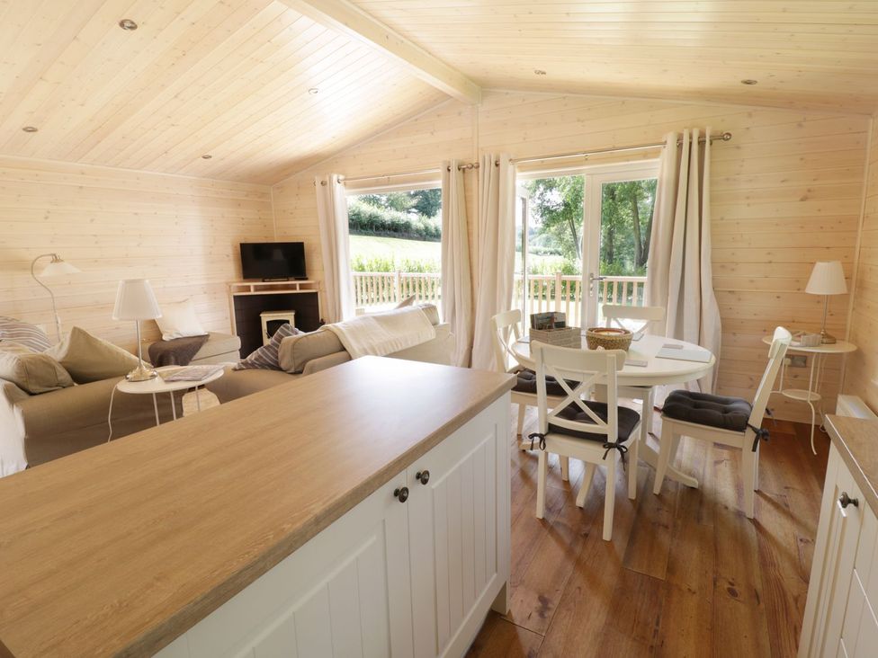 A living room with a sofa and TV at Skylark in Ross-on-Wye