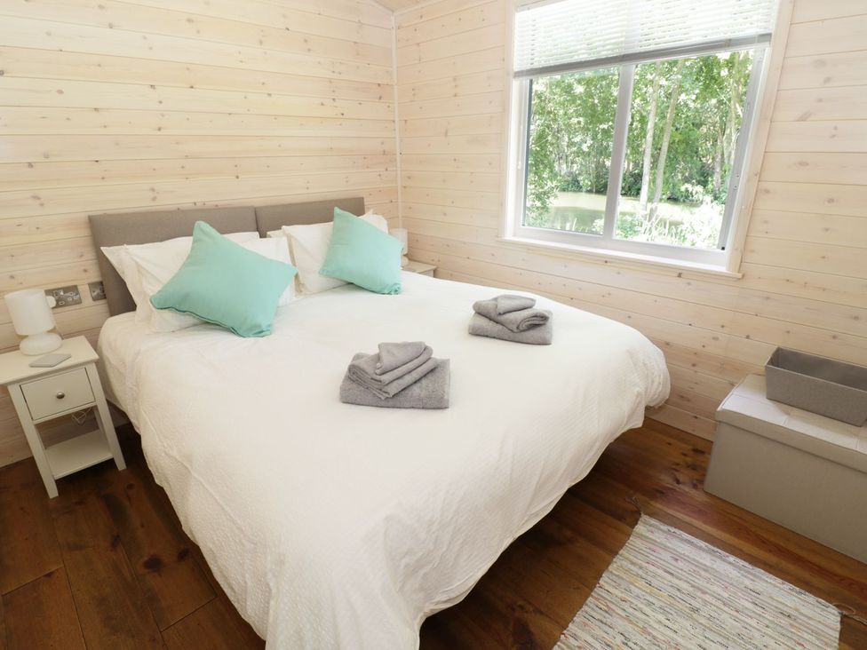 A bedroom with a bed and towels on the bed at Skylark in Ross-on-Wye