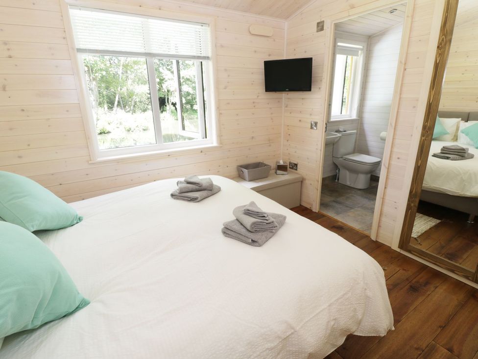 A bedroom with a bed and towels on it at Skylark in Ross-on-Wye