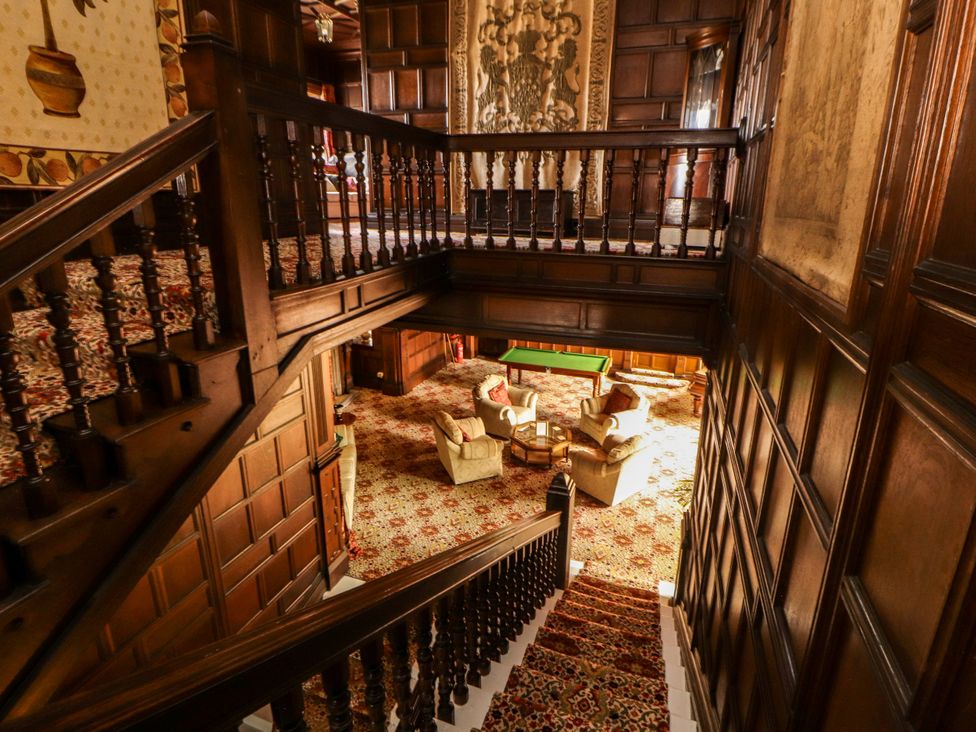 A staircase leading down to an entrance hall with a sofa and coffee table at Rochester Apartment in Orton