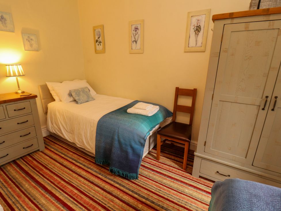 A bedroom with a bed and nightstand at Rochester Apartment in Orton