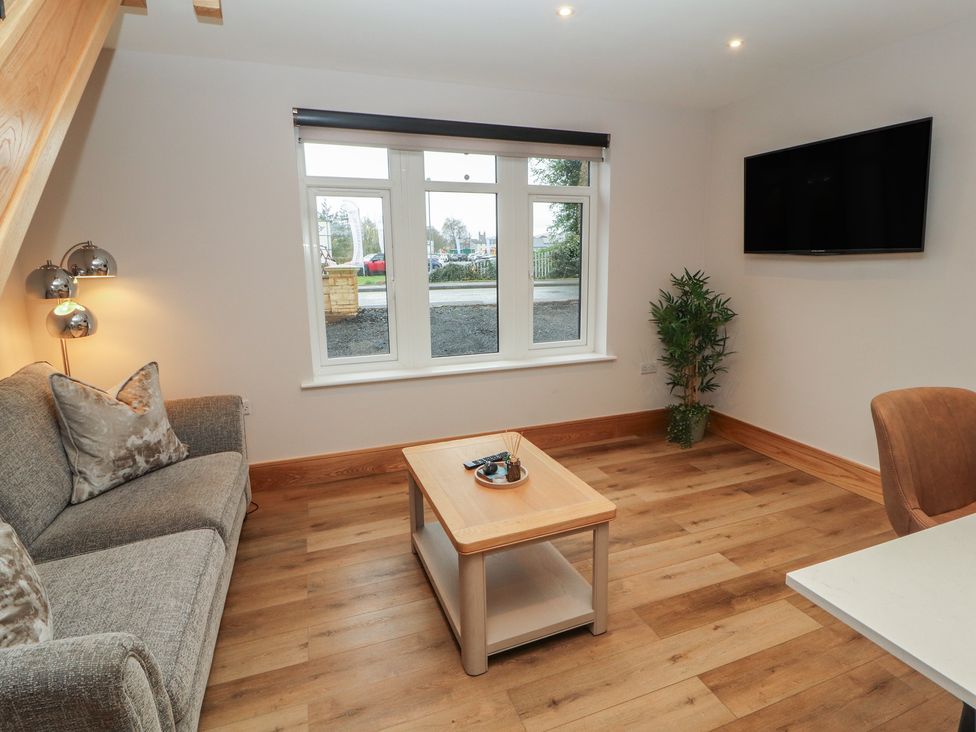 A living room with a sofa and coffee table at The Gate House Annexe Cockermouth