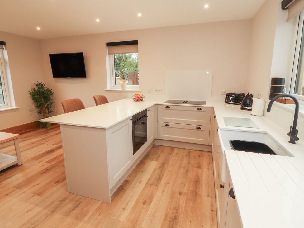 A kitchen with an island and appliances at The Gate House Annexe in Cockermouth