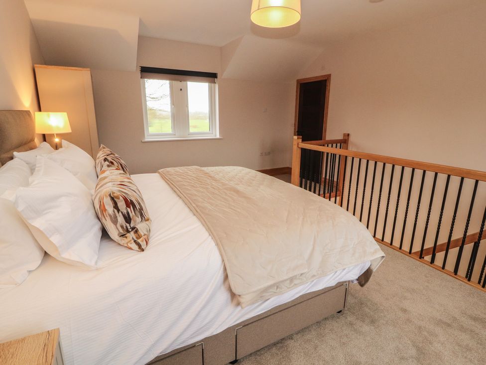 A bedroom with a bed and a window at The Gate House Annexe in Cockermouth