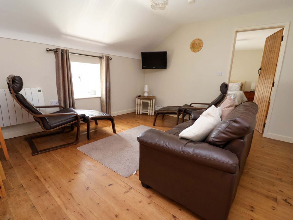 A living room with a sofa and armchairs at Pen Y Grisiau in Mold