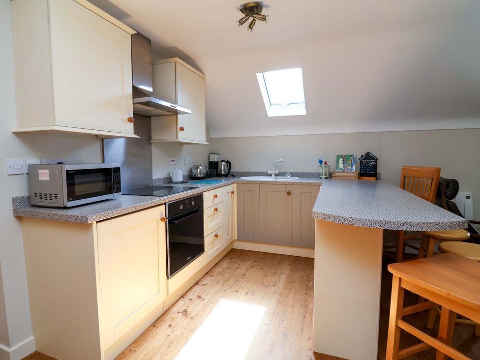 A kitchen with microwave and sink at Pen Y Grisiau in Mold