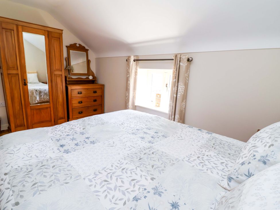A bedroom with a bed, wardrobe, and dresser at Pen Y Grisiau in Mold