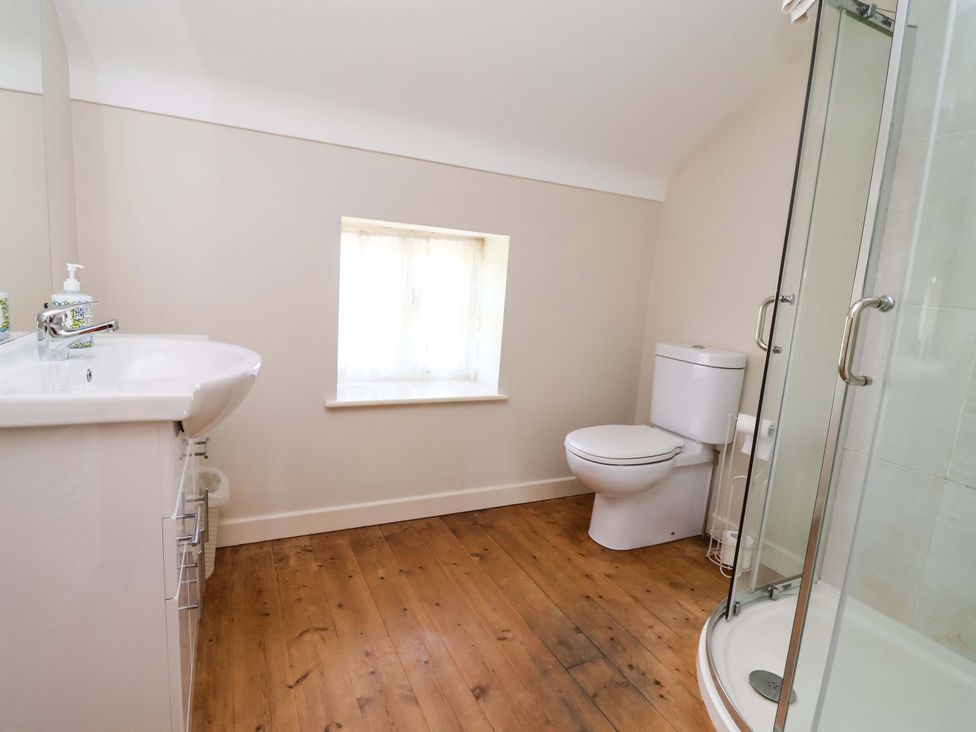 A bathroom with a sink, toilet, and shower at Pen Y Grisiau in Mold