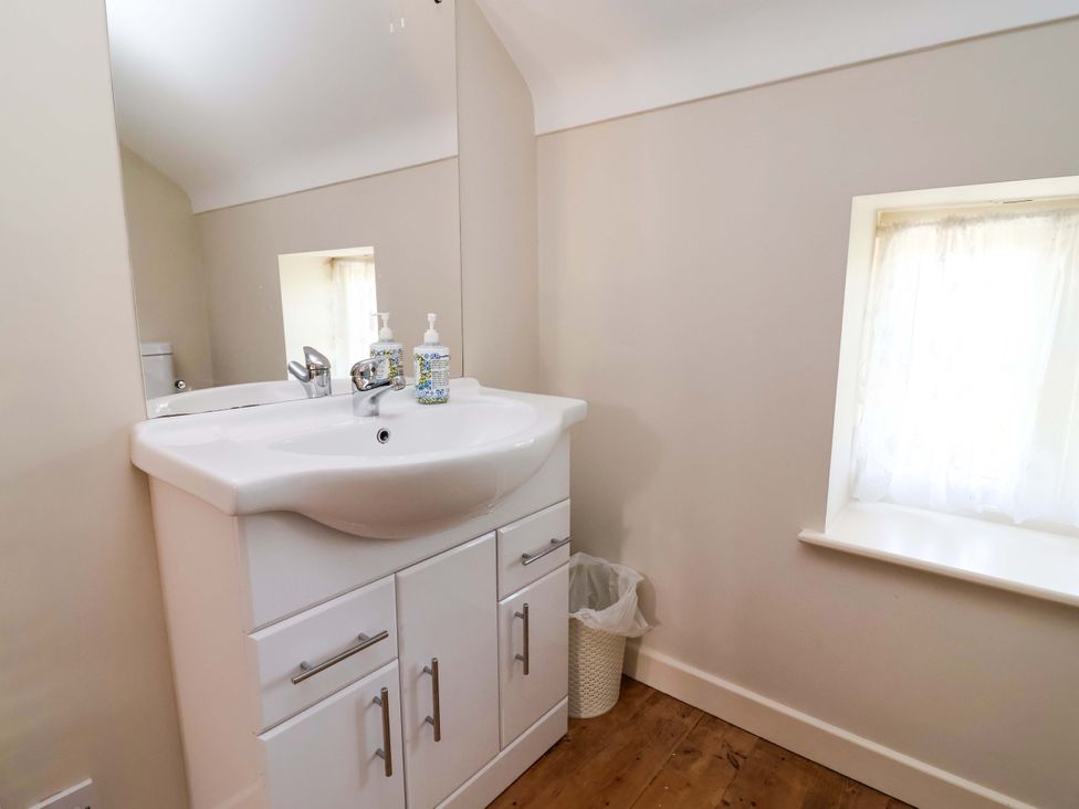 A bathroom with a sink and mirror at Pen Y Grisiau in Mold