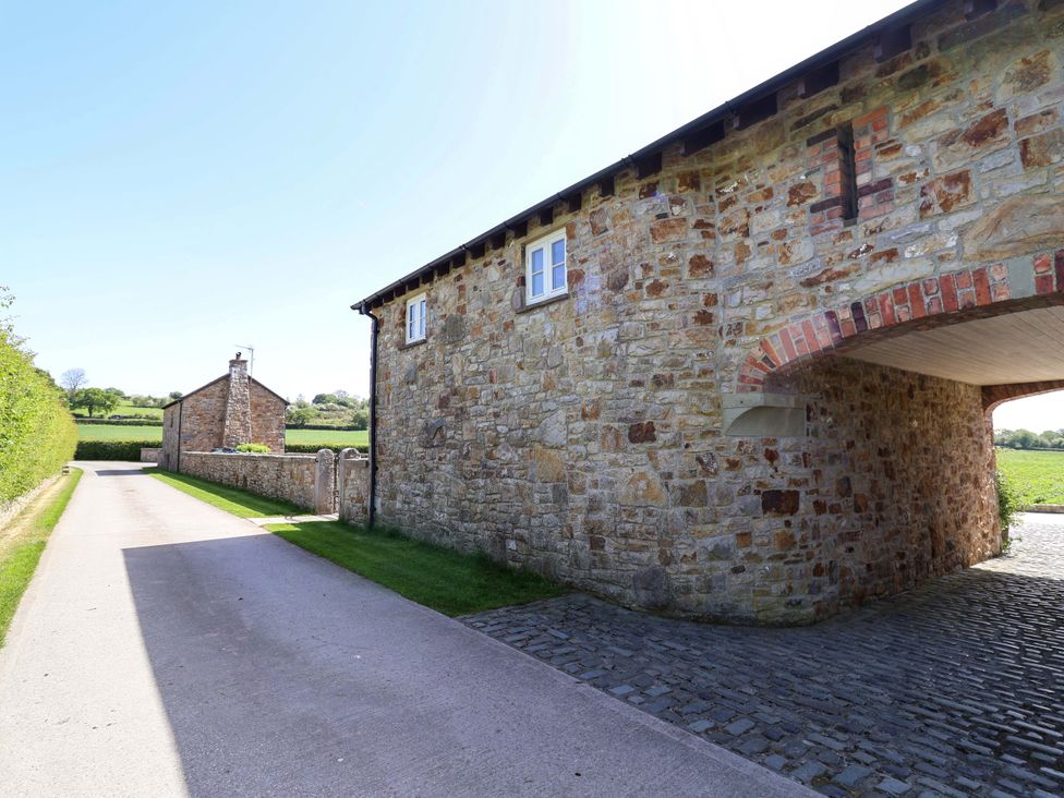 A stone building with a cobblestone path at Pen Y Grisiau in Mold