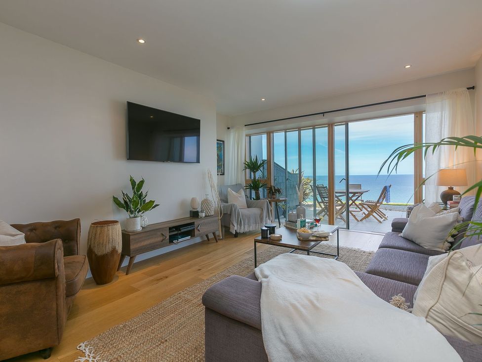 A living room with a television and sofa at Anchors Rest in St. Ives