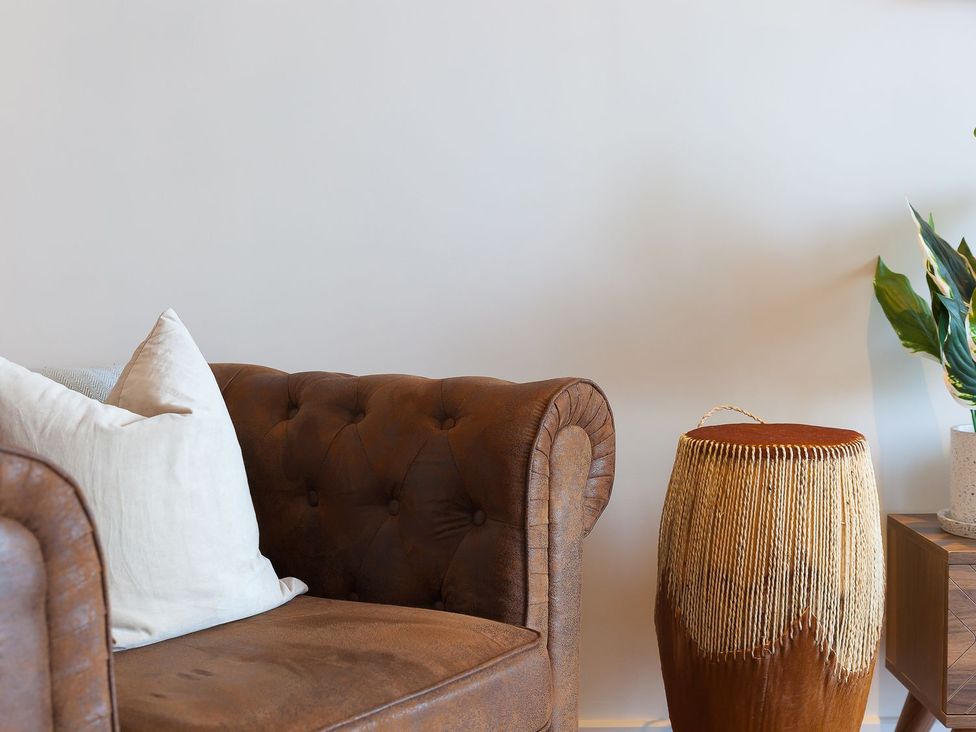 A living room with a sofa and drum at Anchors Rest in St. Ives