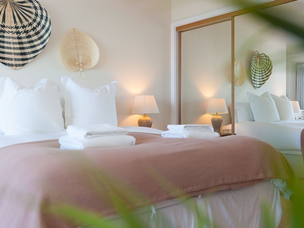 A bedroom with a bed and decorative items at Anchors Rest in St. Ives