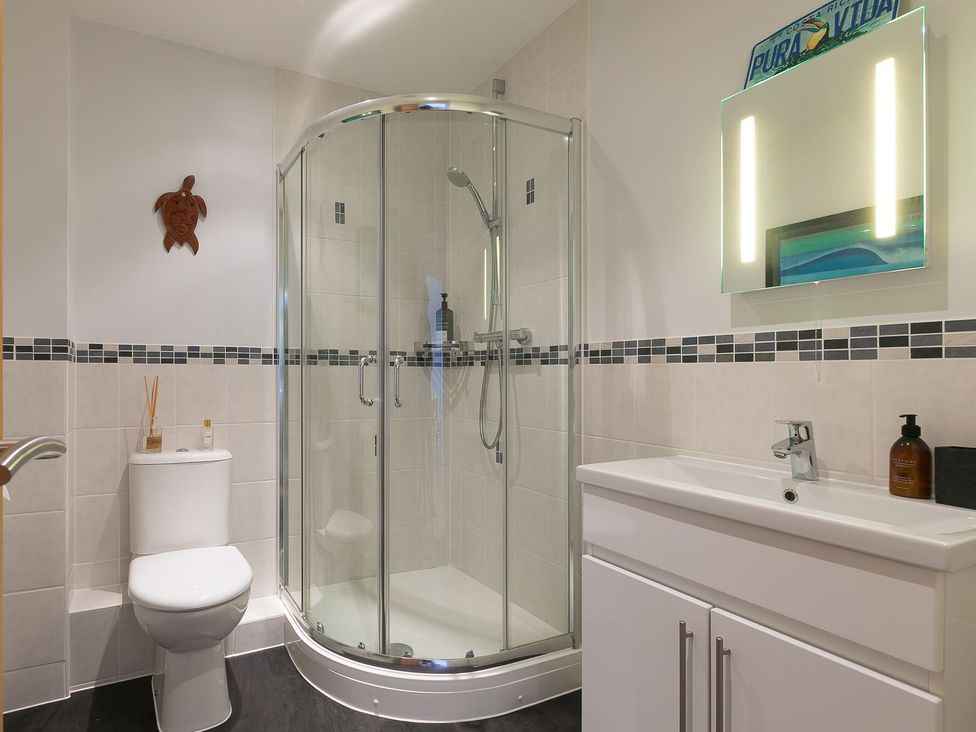 A bathroom with a shower, toilet, and sink at Anchors Rest in St. Ives