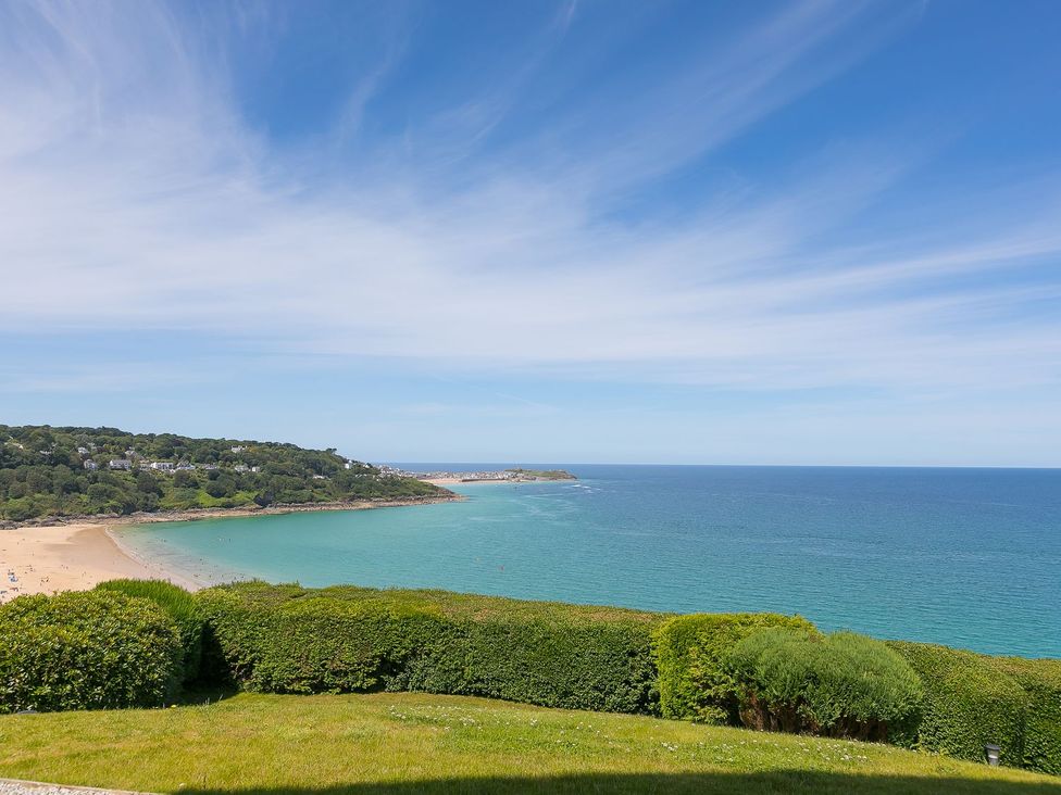 A beach with sand and sea view at Anchors Rest in St. Ives