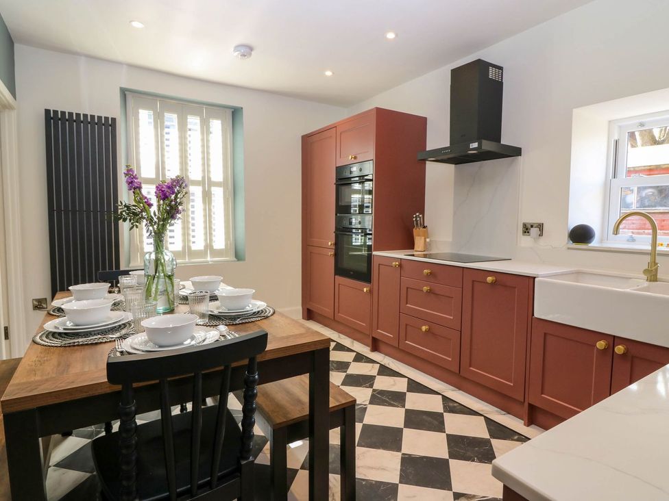 A kitchen with a dining table and chairs at Evansford in Ballater