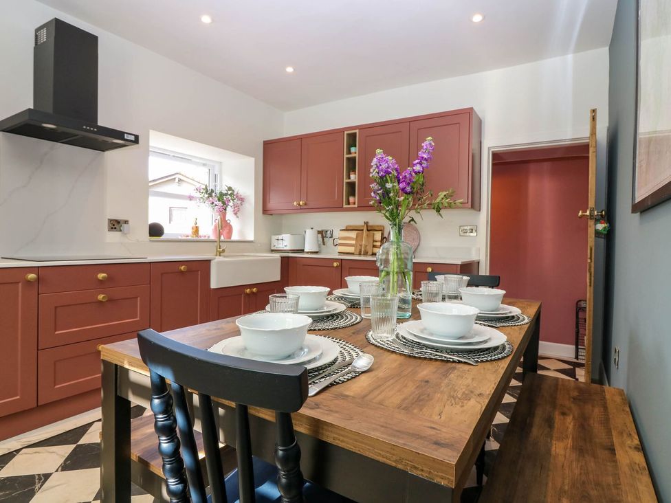 A kitchen with a dining table set for meals at Evansford in Ballater