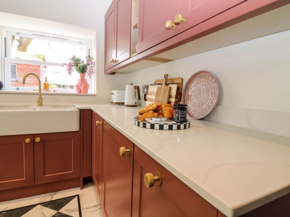 A kitchen with a sink and croissants on the countertop at Evansford in Ballater