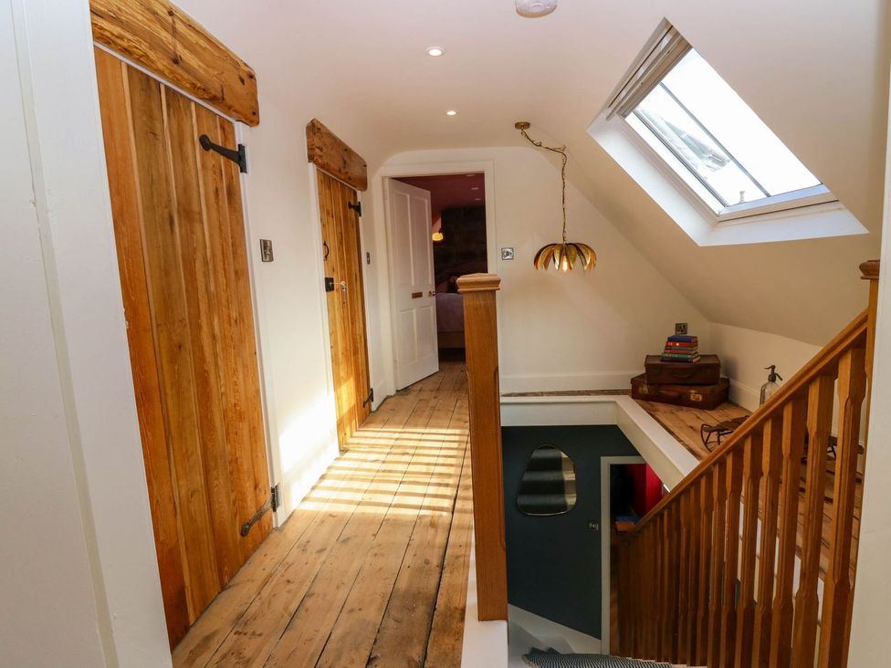 A hallway with wooden doors and a skylight at Evansford in Ballater