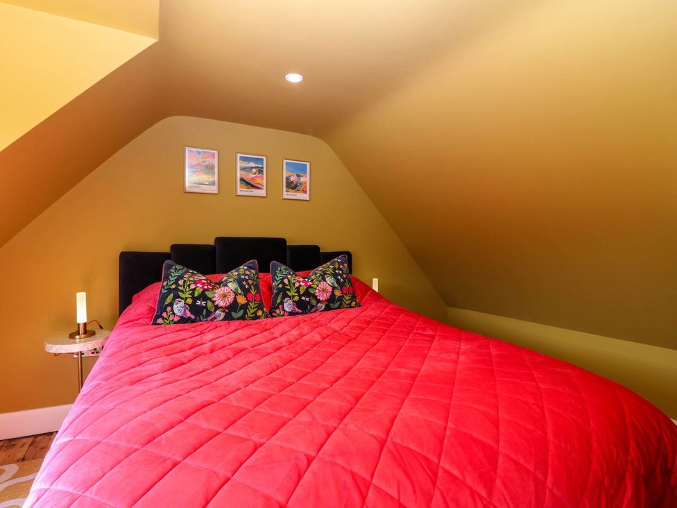 A bedroom with a bed and pictures on the wall at Evansford in Ballater