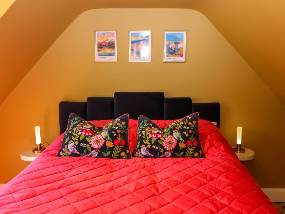 A bedroom with a bed and decorative pillows at Evansford in Ballater