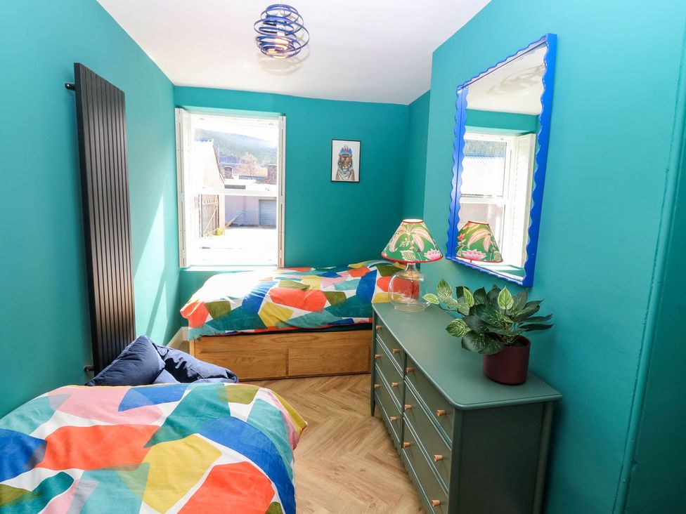 A bedroom with two beds and a dresser at Evansford in Ballater