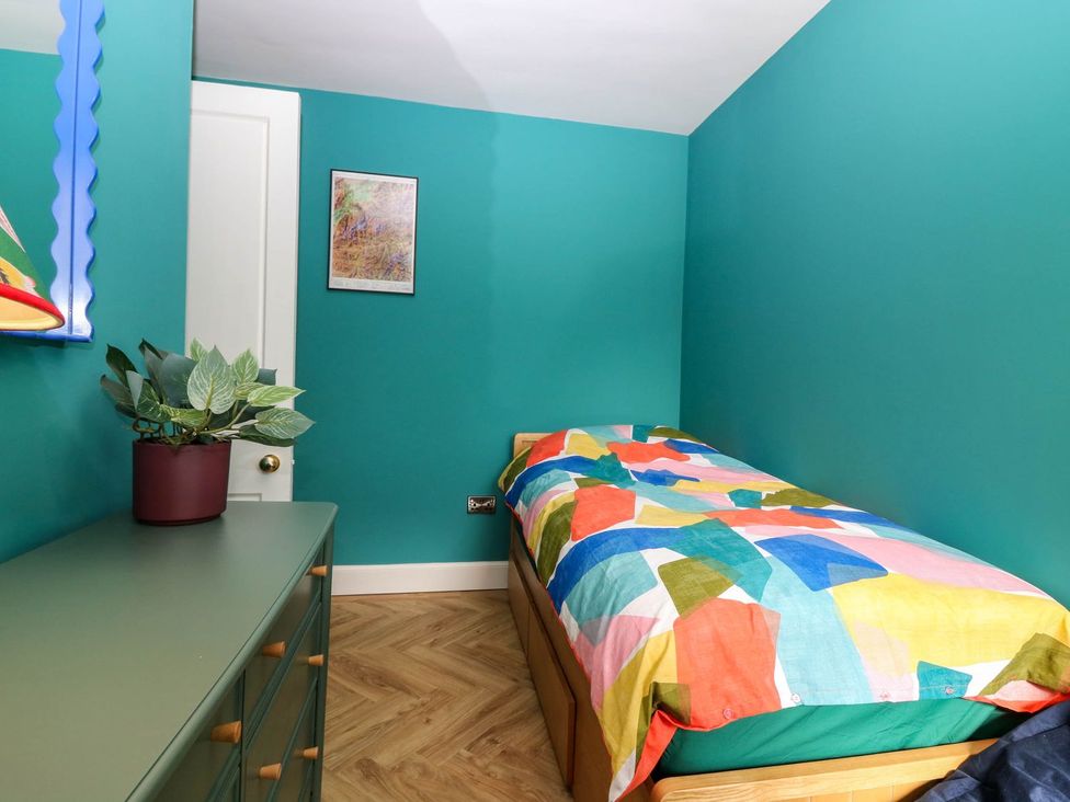 A bedroom with a single bed and a dresser at Evansford in Ballater