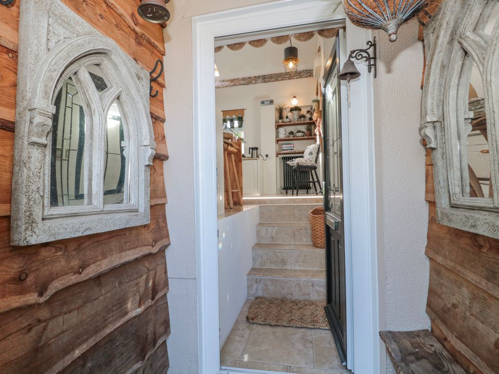 An entryway with stairs leading to a kitchen at 7 The Cedars Wotton-Under-Edge