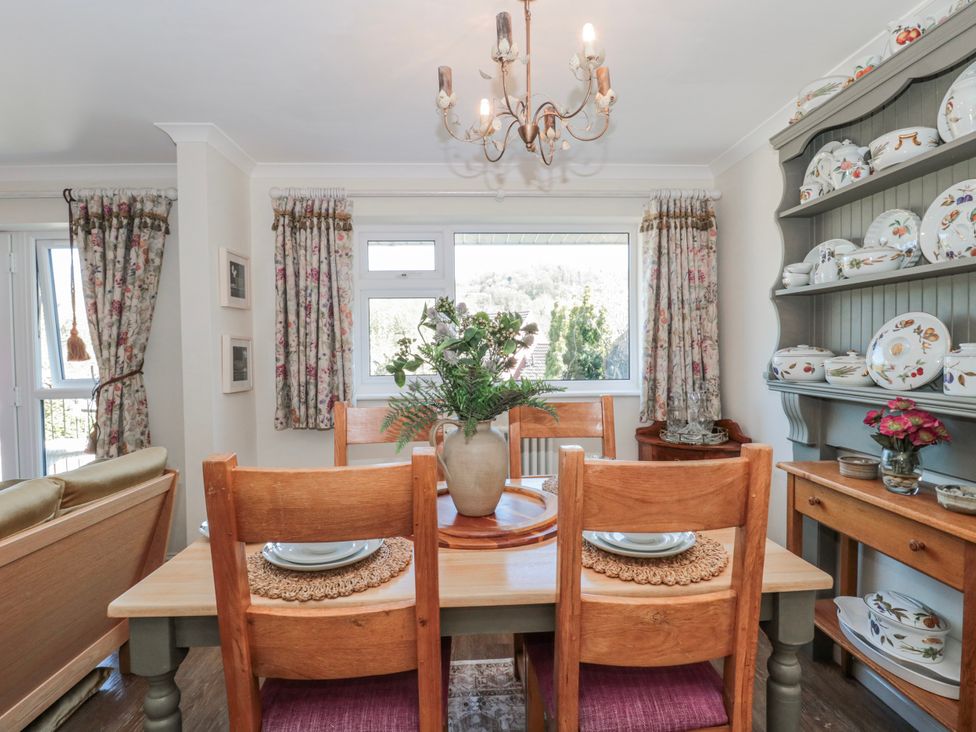 A dining room with a table and chairs at 7 The Cedars in Wotton-Under-Edge