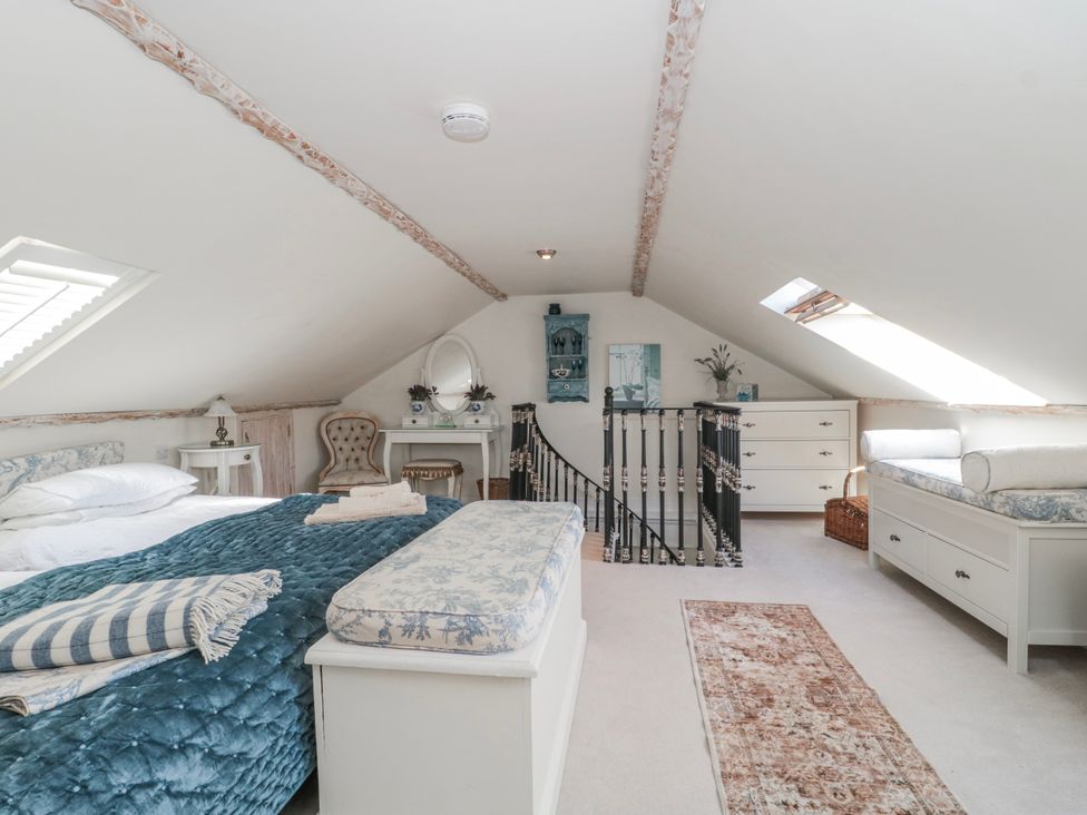 A bedroom with a bed and a dresser at 7 The Cedars in Wotton-Under-Edge