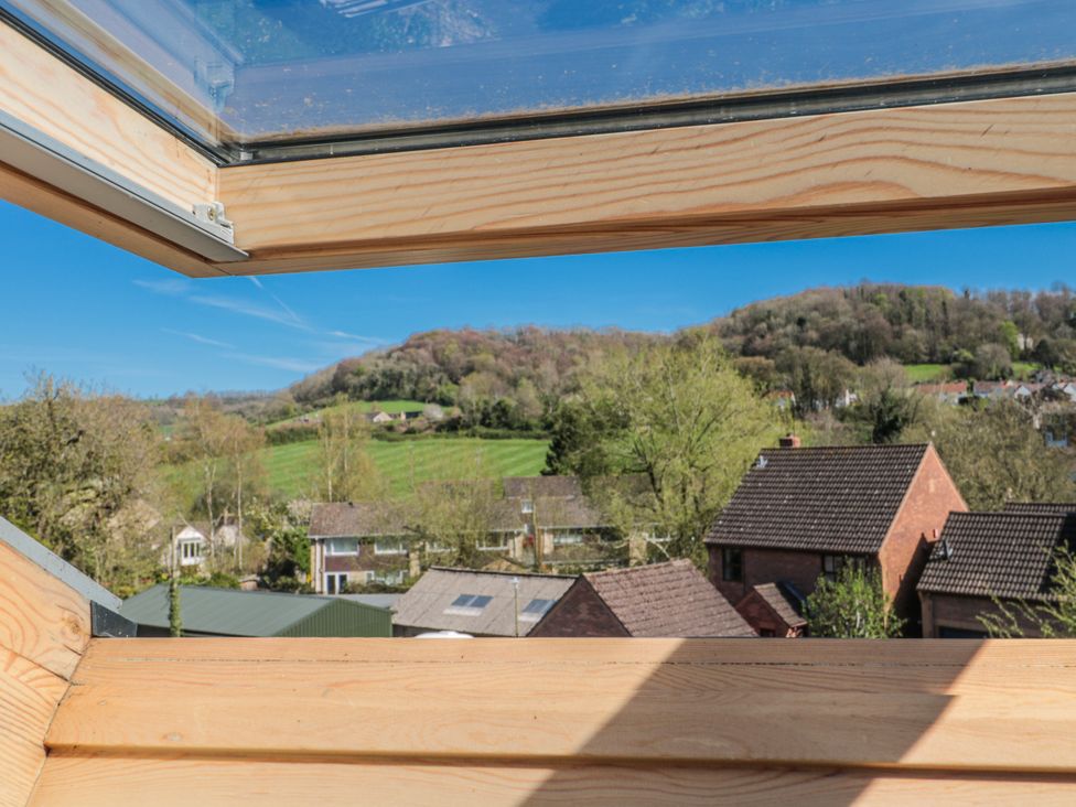 A view from a roof window overlooking hills and houses at 7 The Cedars Wotton-Under-Edge